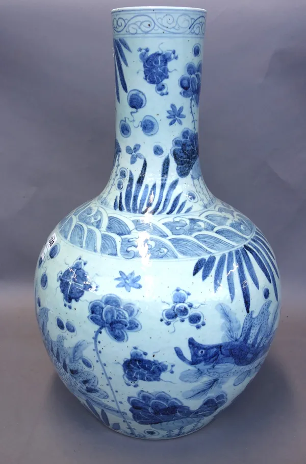 A large Chinese bottleneck blue and white pottery vase, 20th century, decorated all over with Koi carp and stylized flowers, 61cm high.