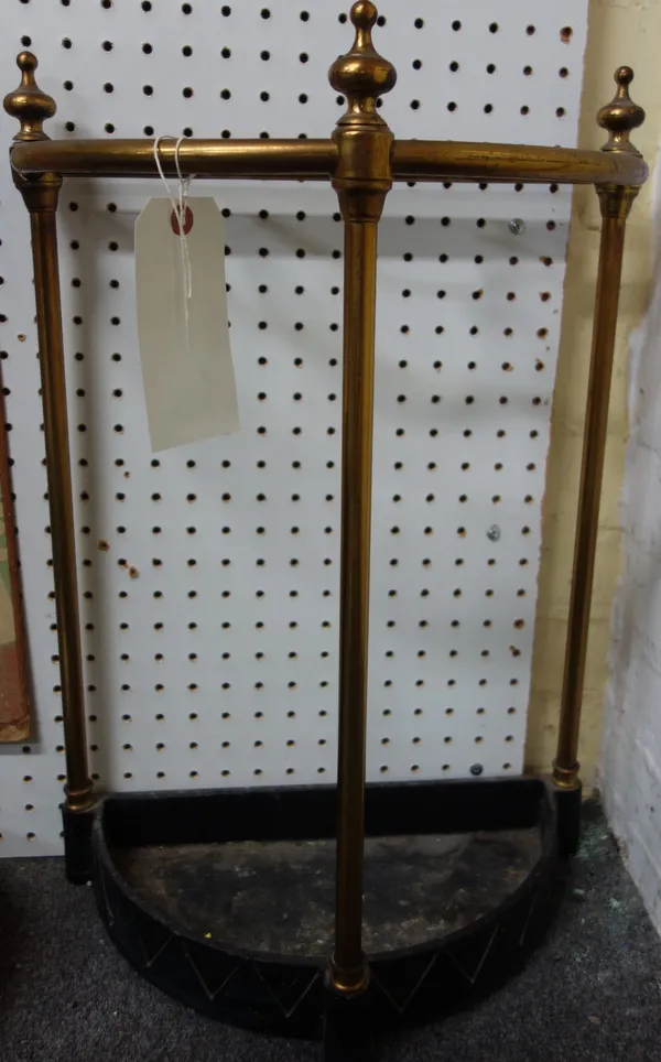A Victorian tubular brass and cast iron four division stick stand of demi-lune form (60cm high) and a brass folding coat rack (74cm wide) (2)