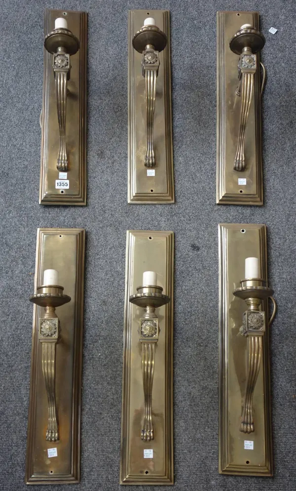 A set of six modern gilt metal single arm wall lights, each stepped rectangular back plate issuing a shaped and fluted arm with applied foliate embell