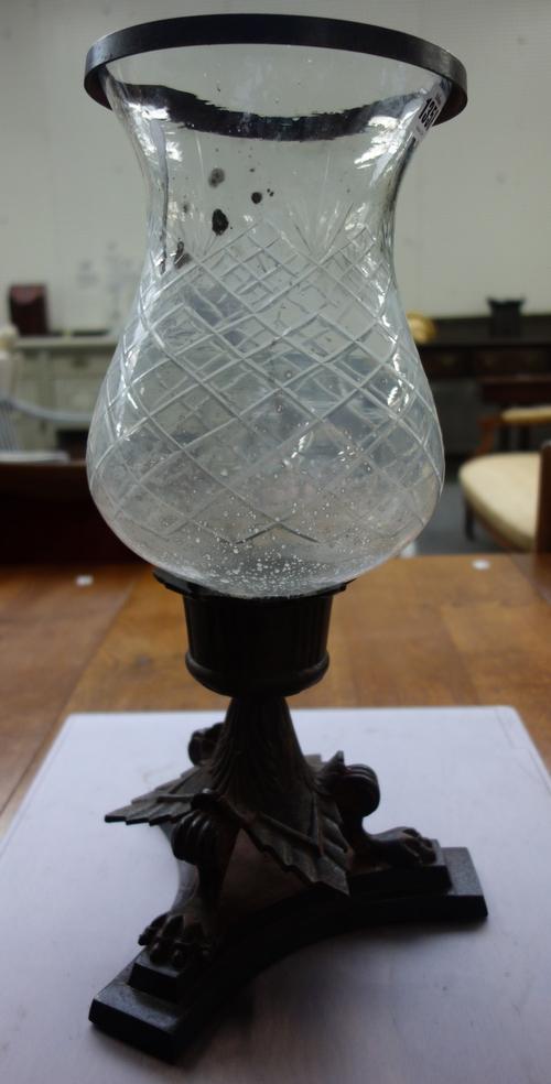 A set of five cast iron and glass hurricane lamps, modern, each tri-form base vasy with lion paw feet supporting a cut glass baluster shade, 44.5cm hi