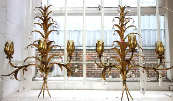 A pair of modern gilt metal three branch wall lights each of leafy foliate form hung with glass drops (50cm high) and a Victorian style brass and cut