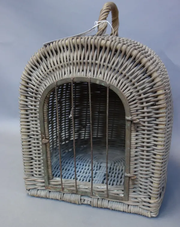 A wicker work cat cage, early 20th century of domed form with single carry handle and a wrought iron door. 36cm high.