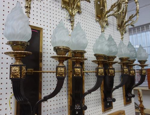 A set of four gilt brass and bronzed metal two branch wall lights, modern, each rectangular back plate issuing two fluted shaped arms with applied met