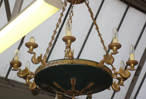 An Empire style green and gilt brass eight branch chandelier, late 20th century, the circular body with foliate cast embellishments issuing eight swan