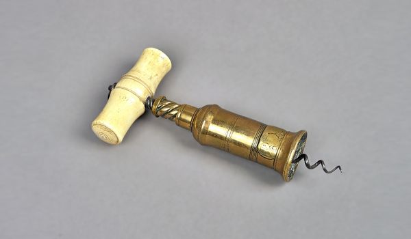 A Thomason type brass cork screw with turned bone handle and applied plaque.  Illustrated