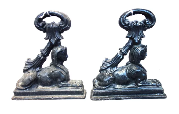 A pair of black painted Egyptian revival cast iron door stops, 19th century, each of half block form cast with Sphinx and scroll loop handle. 24cm hig