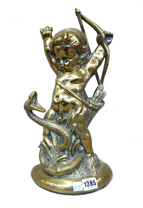 A Victorian brass half block door stop modelled as Cupid fighting a snake (38cm high), two similar black painted cast iron 'Horse' door stops (23cm hi