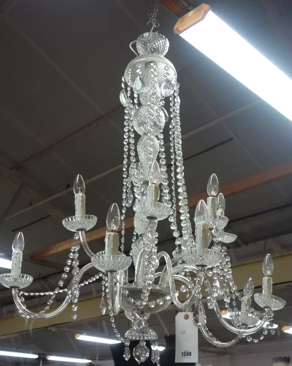 A modern moulded glass twelve light chandelier, the hobnail cut baluster stem issuing twelve glass branches over two graduated tiers untied by beaded
