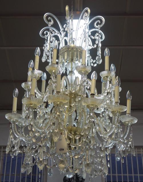 A moulded and cut glass 20 light chandelier, mid late 20th century, with 'Candy cane' spiral twist finials over a baluster stem issuing 20 spiral twis