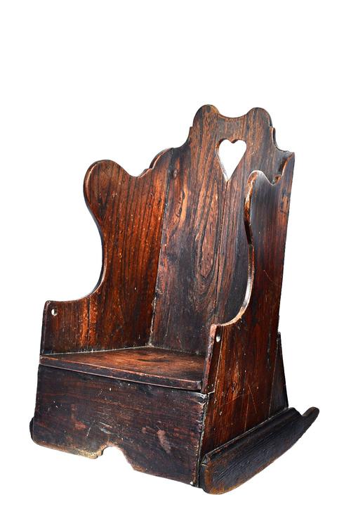 A 19th century oak diminutive lambing chair, on rocking base, 39cm wide x 60cm high.  Illustrated