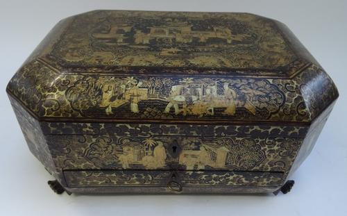An early 19th century Chinese export black lacquer chinoiserie decorated sewing box of compressed octagonal form, with fitted interior, on paw feet, 3