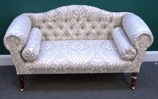 A modern small hump back sofa with roll over arms on turned supports, 140cm wide x 77cm high.