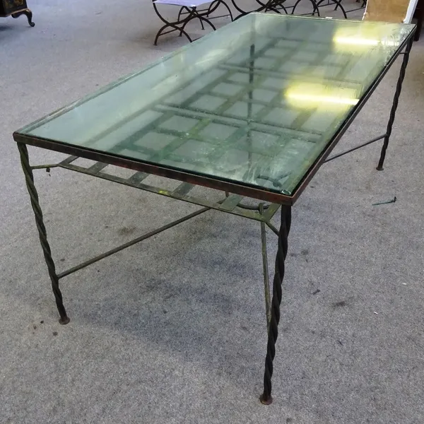 A suite of 20th century iron garden furniture, to comprise; a glass top rectangular table, 87cm wide x 72cm high x 86cm deep, together with eight matc