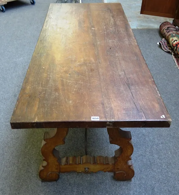 A 17th century style Spanish walnut refectory dining table, on open trestle supports, united by wrought iron stretcher, 160cm long x 65cm wide x 73cm
