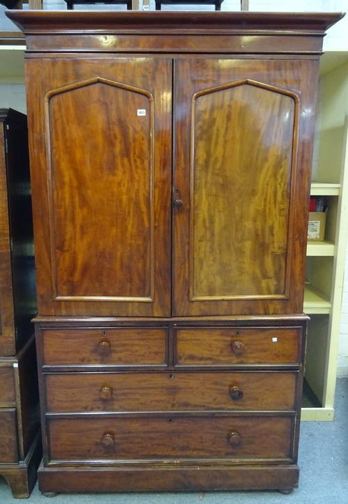 A William IV mahogany linen press, the pair of arch panel doors, over two short and two long drawers, on plinth base, 145cm wide x 213cm high.