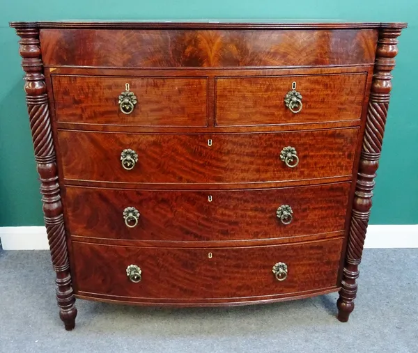 A Regency North Country mahogany bowfront chest of two short and three long graduated drawers, flanked by turned columns, 132cm wide x 128cm high x 60