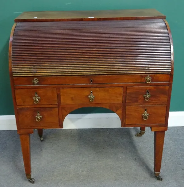 A 19th century mahogany tambour front cylinder bureau with fitted interior over five frieze drawers on tapering square supports, 95cm wide x 107cm hig