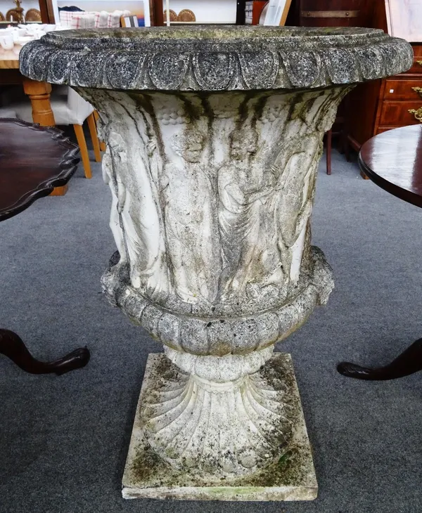 A white painted reconstituted stone garden urn, relief cast with courting classical figures, on fluted socle, 63cm diam. x 94cm high.