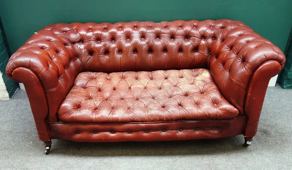 An early 20th century tan button back leather upholstered Chesterfield sofa, on turned supports, 170cm wide x 70cm high x 80cm deep.