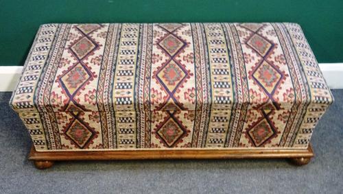 A Victorian rosewood framed lift-top ottoman, of sarcophagus form, 118cm wide x 40cm high x 55cm deep.