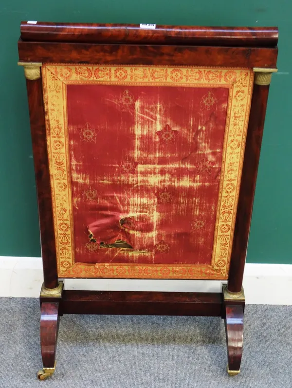 A French Empire gilt metal mounted mahogany height adjustable fire screen, on four downswept supports, 55cm wide x 92cm high x 148cm high extended.