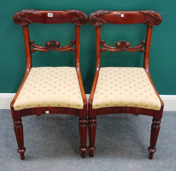 'Downey'; a pair of William IV mahogany dining chairs, with concave seats on tapering reeded supports, stamped, each 45cm wide x 84cm high x 53cm deep
