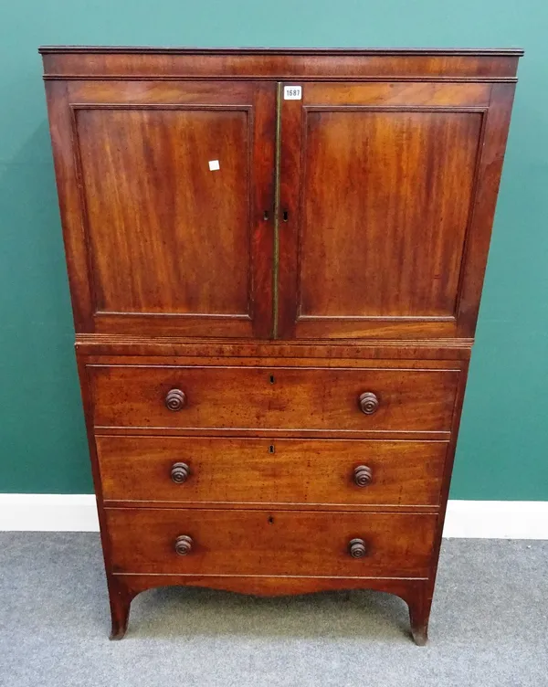 An early 19th century mahogany linen press, of small proportions, the pair of panel doors over three long drawers, on splayed bracket feet, 91cm wide