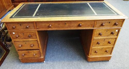 A Victorian oak pedestal desk, with nine drawers about the knee, on plinth base, 135cm wide x 67cm high x 66cm deep.