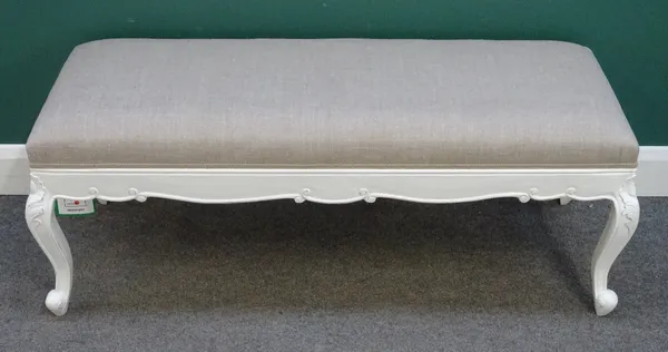 A 19th century style rectangular footstool, with white painted floral capped scroll supports, 128cm wide x 50cm high x 50cm deep.