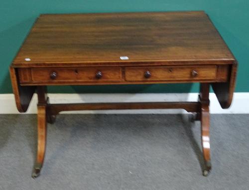 A Regency faux satinwood banded rosewood sofa table, with a pair of frieze drawers on trestle end standards and four downswept supports, 101cm across