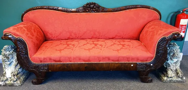 A 19th century Continental carved mahogany framed sofa, with shaped crest rail and opposing eagle arm supports, raised on cornucopia feet, 220cm wide