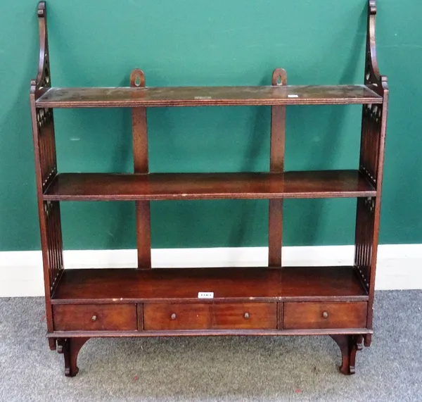 A set of 19th century Gothic Revival mahogany hanging three tier wall shelves with three lower drawers and pierced sides, 70cm wide x 87cm high x 17cm