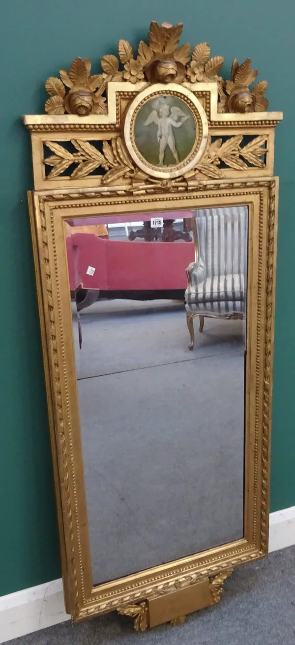 A 19th century French gilt framed wall mirror, the floral carved crest with painted cherub roundel over two part bevelled rectangular plate, 62cm wide