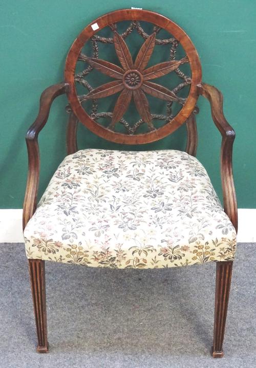 A 19th century mahogany carver chair, with floral carved wheel back on channelled square supports, 60cm wide x 90cm high. 7.10