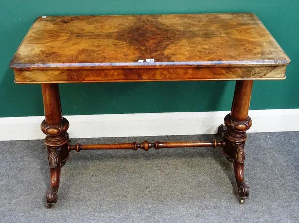 A Victorian figured walnut centre table, the rectangular top on a pair of carved columns and four downswept supports, 107cm wide x 59cm deep x 74cm hi