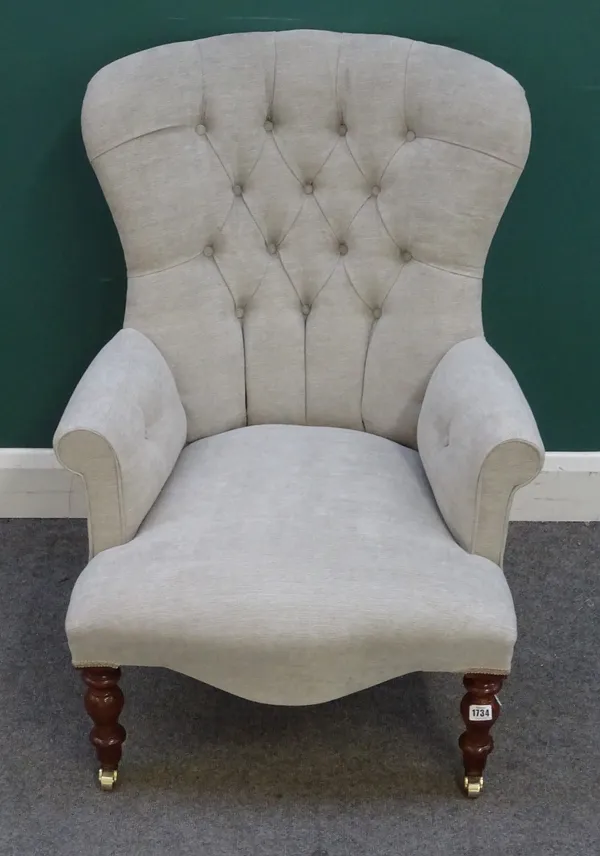 A modern button back armchair, of mid 19th century style, on turned supports, 67cm wide x 95cm high.