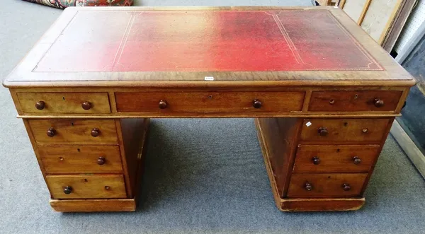 A 19th century mahogany pedestal partner's desk, with nine drawers about the kneehole and opposing pedestal cupboards, 153cm wide x 77cm high x 90cm d