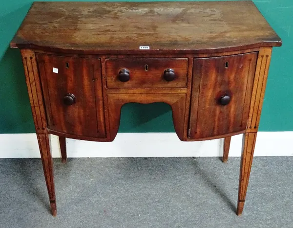 A late George III inlaid mahogany small bowfront sideboard, the frieze with pair of drawers and cupboards, on tapering square supports, 91cm wide x 83