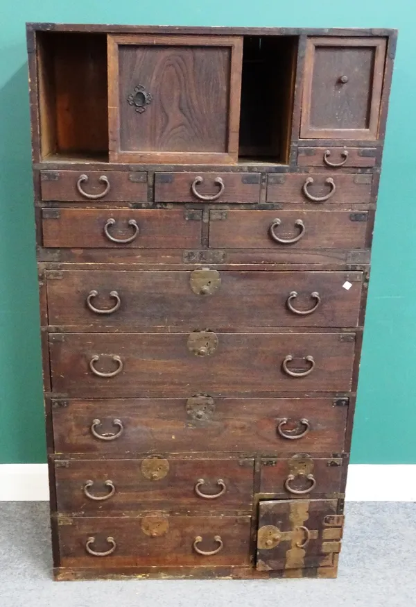 A late 19th century Korean side cabinet, with three cupboards over twelve drawers, 89cm wide x 160cm high x 40cm, deep.