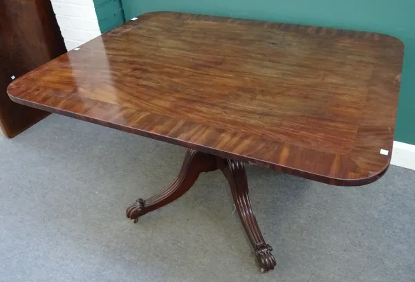 A George IV crossbanded mahogany breakfast table, the rectangular snap top on spiral fluted column and four downswept supports, 130cm wide x 100cm dee