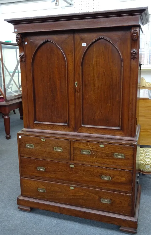 A 19th century oak linen press, the pair of Gothic arched doors over two short and two long drawers, on bracket feet, 121cm wide x 190cm high, 67cm de
