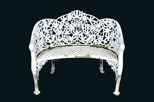 After Coalbrookdale, a white painted cast aluminium passion flower pattern concave garden bench, taken from a design in the 1875 catalogue, number 32,
