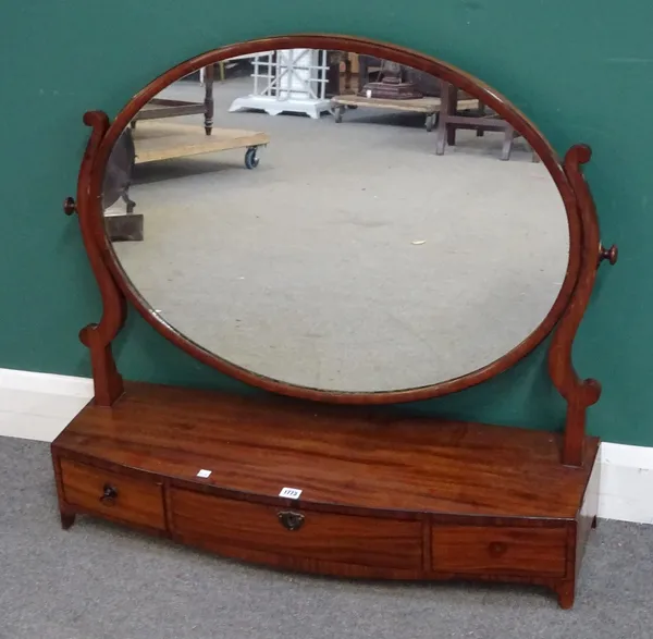 A large George III mahogany swing frame toilet mirror, with bow three drawer base, 94cm wide x 86cm high.