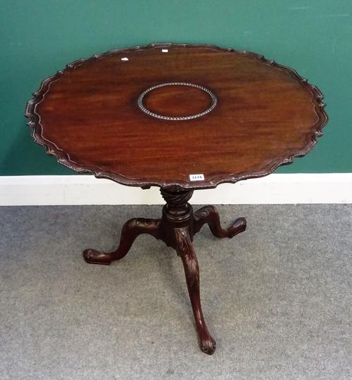 A George III mahogany occasional table, the pie-crust snap top on birdcage mount and carved tripod base, 84cm diameter x 71cm high.