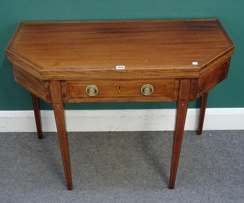 A late George III inlaid mahogany card table, the canted rectangular top over frieze drawer, on tapering square supports, 95cm wide x 69cm high x 46cm