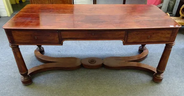 A large 19th century mahogany centre table, the rounded rectangular top over three frieze drawers on turned supports, united by shaped 'X' frame stret