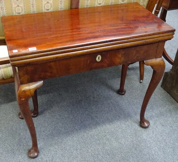 A mid 18th century mahogany triple foldover games table on cabriole supports and club feet, 84cm wide x 76cm high x 41cm deep.
