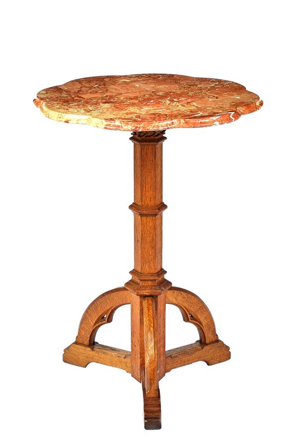 A 19th century occasional table, the later shaped marble top on a Gothic Revival carved oak tripod base, 56cm wide x 76cm high.  Illustrated