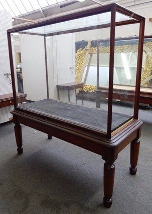 A large glazed mahogany framed free-standing museum display cabinet, on four tapering turned supports, 181cm wide x 85cm deep x 194cm high.