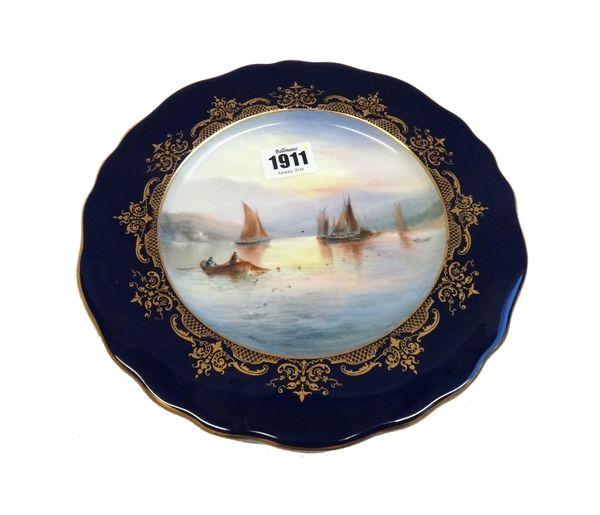 A Royal Worcester plate painted by Harry Davis, circa 1903, painted with boats and fishermen in a loch, signed H.Davis, inside a gilt frame and cobalt